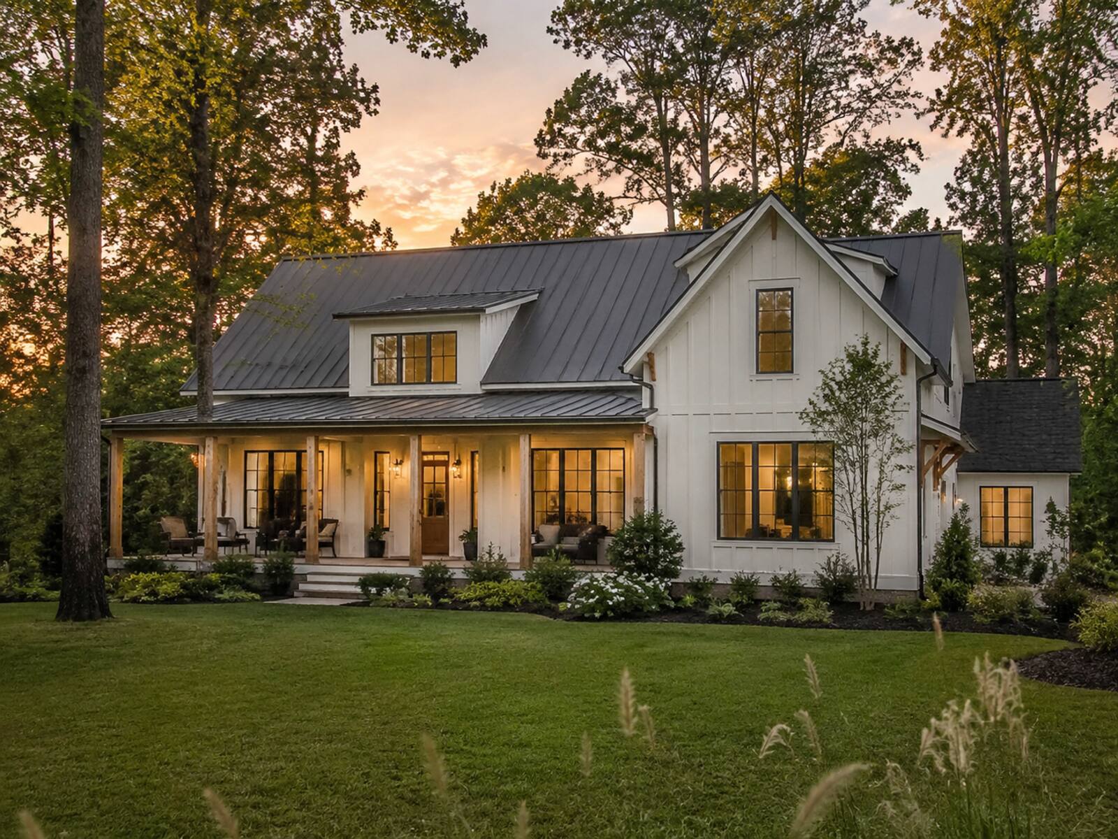 A crisp white modern farmhouse new-construction home at dusk